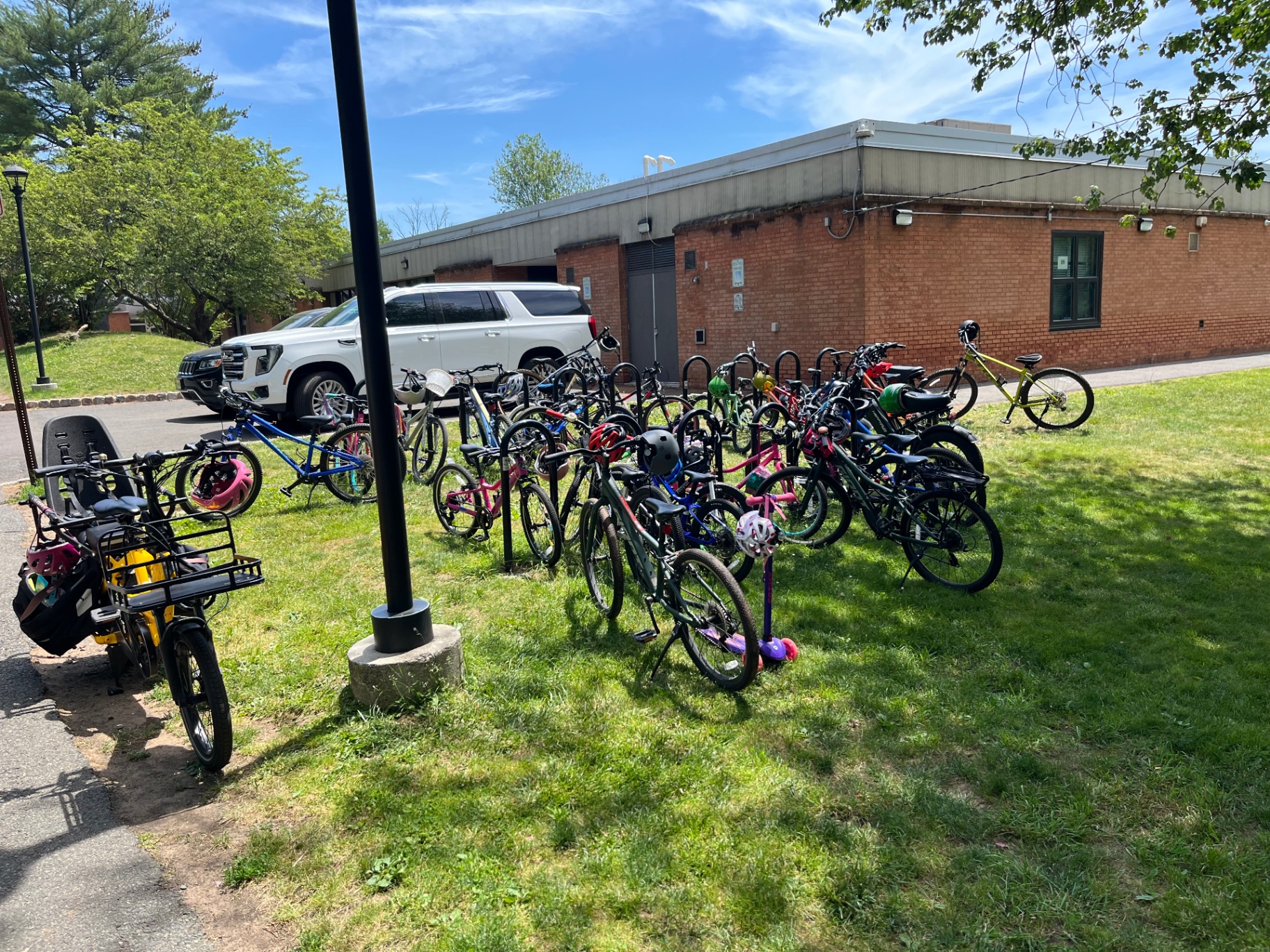 Bike rack full of children's bikes at Salt Brook Elementary School on a sunny June day